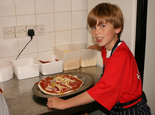 Matthew with a prepared pizza