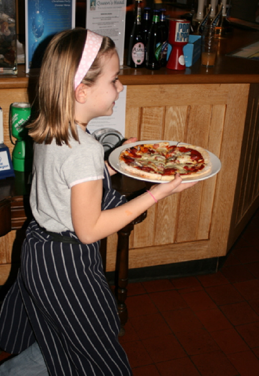 Kate serving a pizza